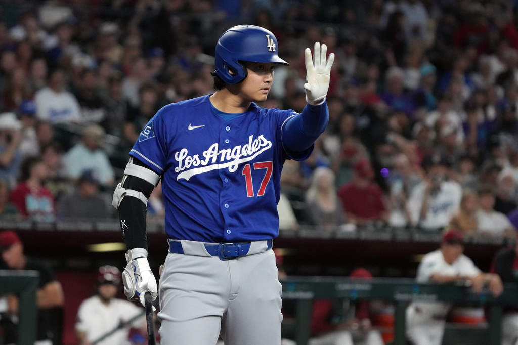 Los Angeles Dodgers' Shohei Ohtani reacts after hitting the ball against the Arizona Diamondbacks in the first inning of a baseball game, Sunday, Aug 9, 2026, in Phoenix. (AP Photo/Rick Scuteri)