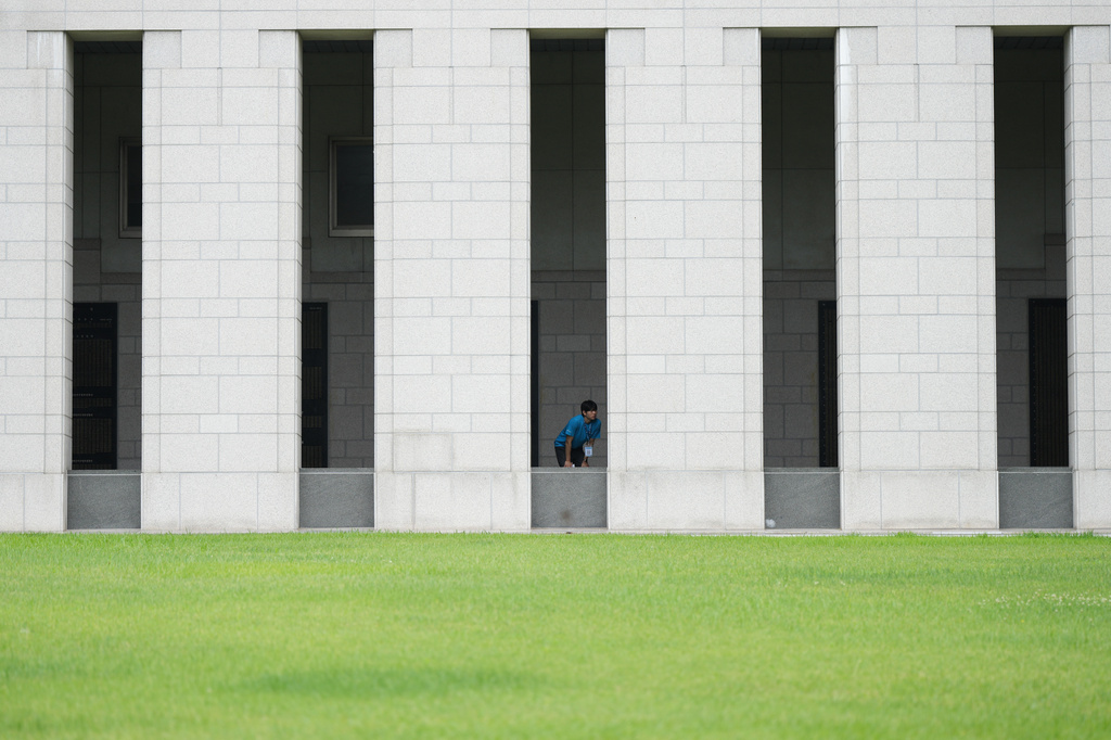 South Korean student Min Woo-jin looks at monuments with the names of soldiers killed during the 1950-53 Korean War, at the War Memorial of Korea in Seoul, South Korea, Sunday, July 5, 2026. (AP Photo/Lee Jin-man)