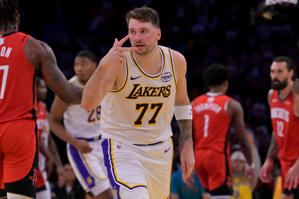 Los Angeles Lakers guard Luka Doncic reacts after a three-point basket during the first half of an NBA basketball game against the Houston Rockets, Thursday, Dec. 25, 2025, in Los Angeles. (AP Photo/Jayne Kamin-Oncea)