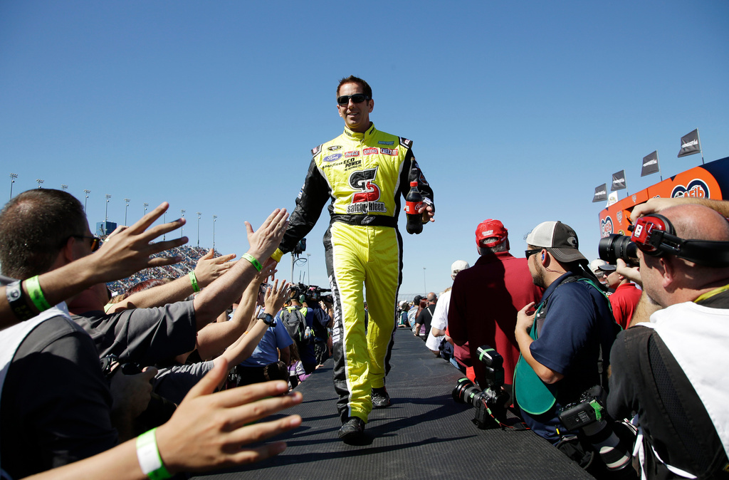 FILE - Greg Biffle greets fans during drivers introduction before the NASCAR Sprint Cup Series auto race at Chicagoland Speedway, Sept. 20, 2015, in Joliet, Ill. (AP Photo/Nam Y. Huh, File)