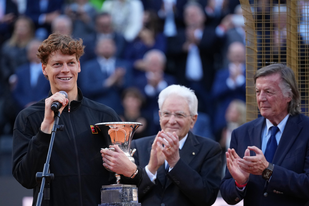 Jannik Sinner, of Italy, holds his trophy while Italian President Sergio Mattarella, center, and former tennis champion Adriano Panatta applaud, after defeating Casper Ruud, of Norway, in the final match to win the Italian Open tennis tournament, in Rome, Sunday, May 17, 2026. (AP Photo/Andrew Medichini)