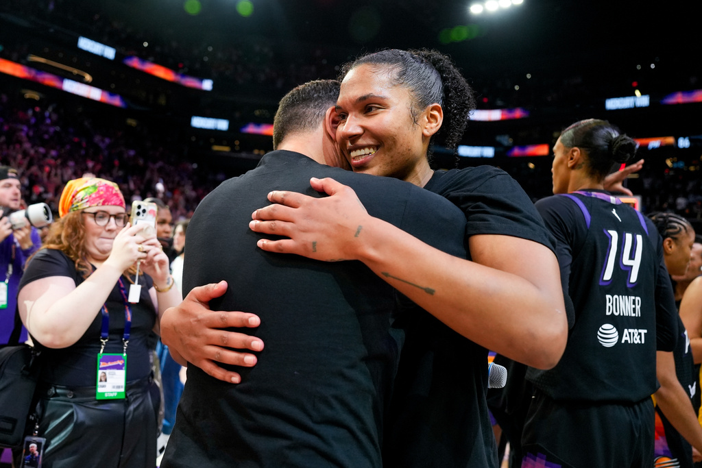 Phoenix Mercury forward Alyssa Thomas (right) celebrates after winning Game 4 of a WNBA basketball playoff semifinals series against the Minnesota Lynx, Sunday, Sept. 28, 2025, in Phoenix. (AP Photo/Samantha Chow)