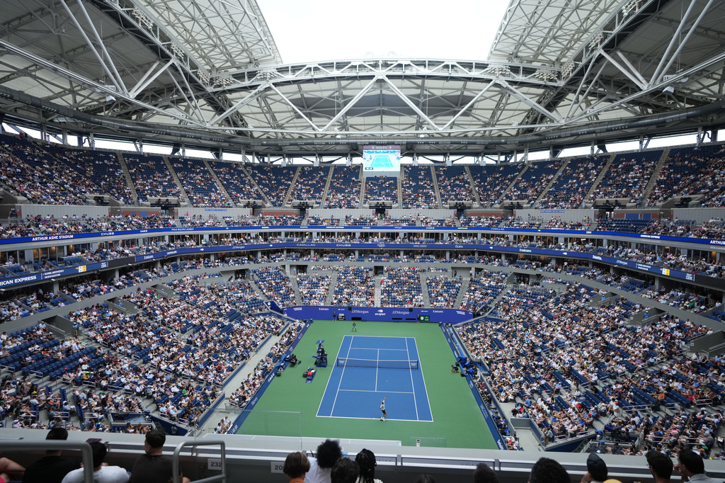 Daniil Medvedev, of Russia, serves the ball to Hugo Gaston, of France, top, during the first round of the U.S. Open tennis championships at Arthur Ashe Stadium on Sunday, Aug. 30, 2026, in New York. (AP Photo/Kirsty Wigglesworth)