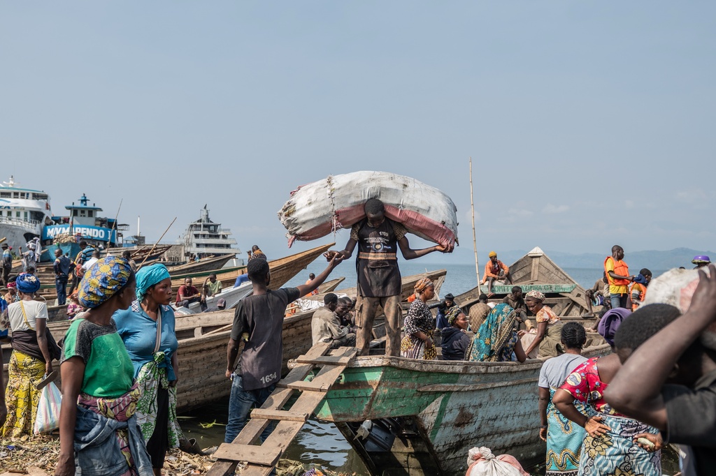 Workers unload goods from boats on the shores of Lake Kivu in Goma, Democratic Republic of the Congo, Monday, Jan. 26, 2026, a year after M23 took control of the city. (AP Photo/Moses Sawasawa)