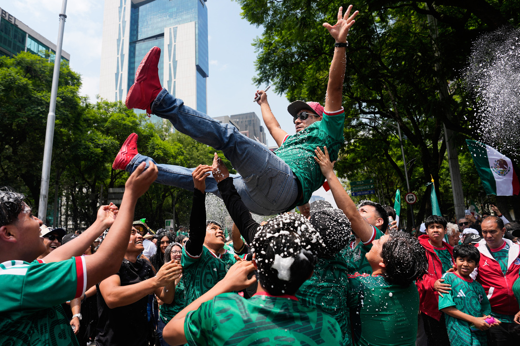 Soccer fans get revved up at a watch party on Reforma Ave., near the Angel of Independence monument, for the World Cup soccer match between Mexico and Ecuador, in Mexico City, Tuesday, June 30, 2026. (AP Photo/Marco Ugarte)