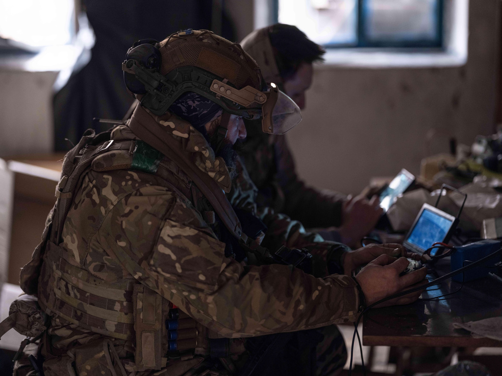 In this photo provided by Ukraine's 93rd Kholodnyi Yar Separate Mechanized Brigade press service, soldiers control an FPV drone to send food to fellow-soldiers on a mission on the frontline near Kostyantynivka, Donetsk region, Ukraine, Tuesday, Feb. 17, 2026. (Iryna Rybakova/Ukraine's 93rd Mechanized Brigade via AP)