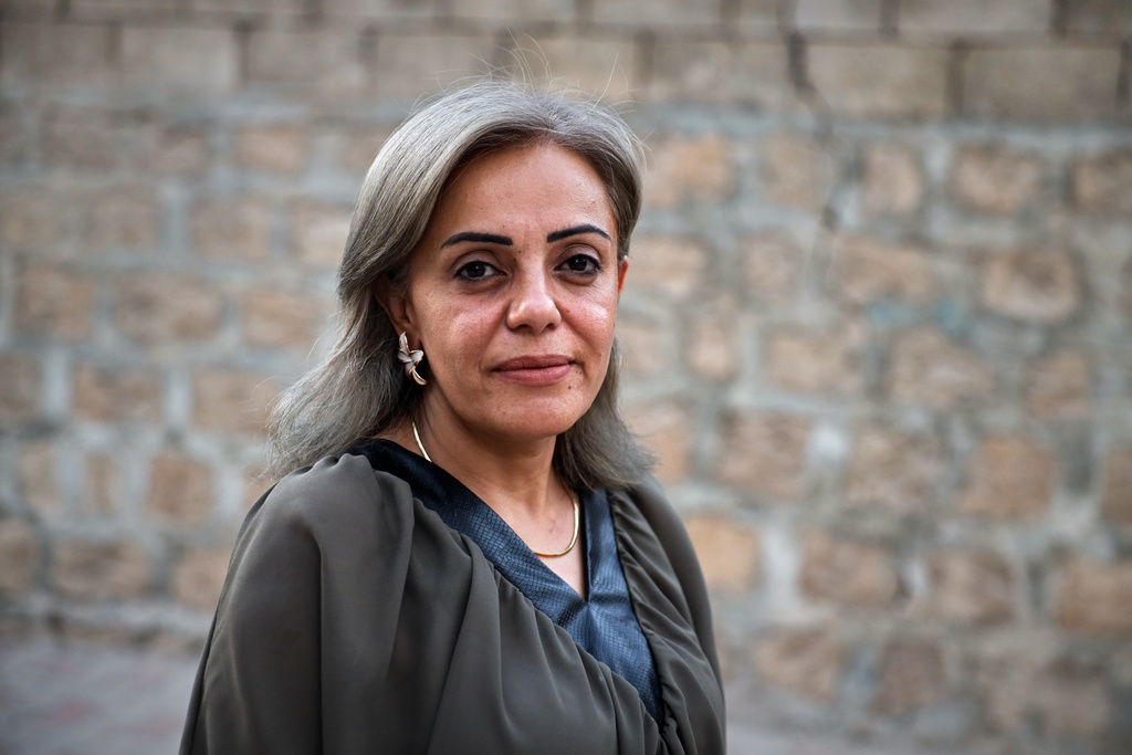 Kurdish health worker Dr. Rankin Abdow poses for a photo after winning a seat for the Afrin region in Syria's parliamentary election, in Aleppo, Syria, Sunday, Oct. 5, 2025. (AP Photo/Omar Albam)