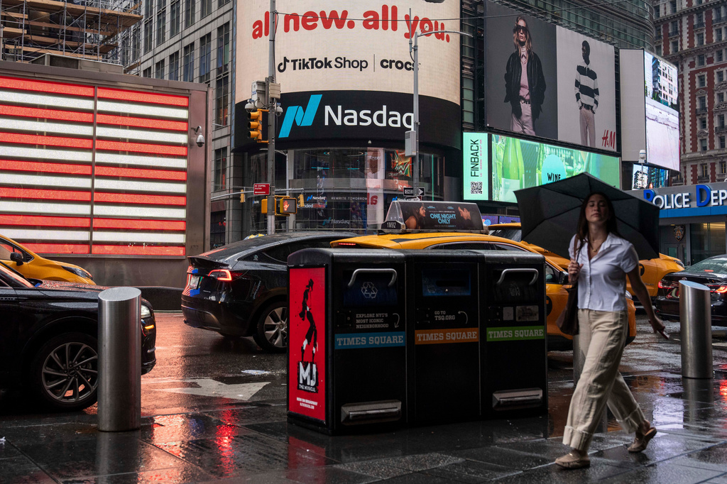 People walk past the Nasdaq MarketSite, Thursday, Aug. 6, 2026, in New York. (AP Photo/Yuki Iwamura)