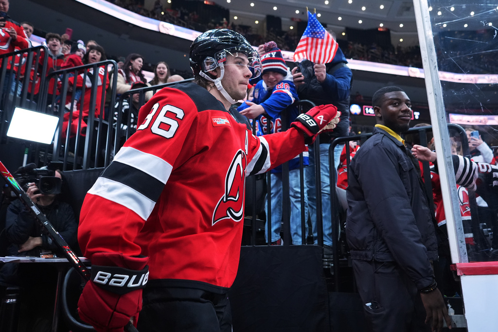New Jersey Devils' Jack Hughes (86) greets fans as he walks toward the ice before an NHL hockey game against the Buffalo Sabres Wednesday, Feb. 25, 2026, in Newark, N.J. (AP Photo/Frank Franklin II)