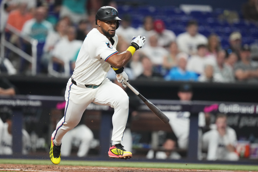Miami Marlins' Otto Lopez runs to reach on a fielding error by Philadelphia Phillies first baseman Alec Bohm during the third inning of a baseball game, Tuesday, July 28, 2026, in Miami. (AP Photo/Lynne Sladky)
