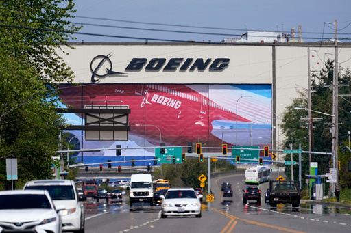 FILE - Traffic drives in view of a Boeing Co. production plant, where images of jets decorate the hangar doors on April 23, 2021, in Everett, Wash. (AP Photo/Elaine Thompson, File) FILE - Traffic drives in view of a Boeing Co. production plant, where images of jets decorate the hangar doors on April 23, 2021, in Everett, Wash. (AP Photo/Elaine Thompson, File)