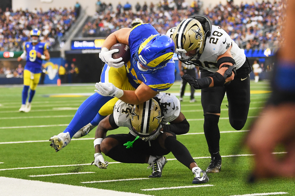 Los Angeles Rams tight end Davis Allen (87) is tackled by New Orleans Saints cornerback Kool-Aid McKinstry (4) and safety Julian Blackmon (28) in the second half of an NFL football game Sunday, Nov. 2, 2025, in Inglewood, Calif. (AP Photo/Katie Chin)