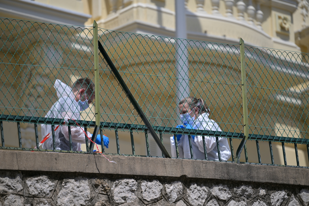 Investigators examine the scene at the residential building where an explosive device seriously injured three people a day earlier in Monaco, Tuesday, June 30, 2026. (AP Photo/Philippe Magoni)