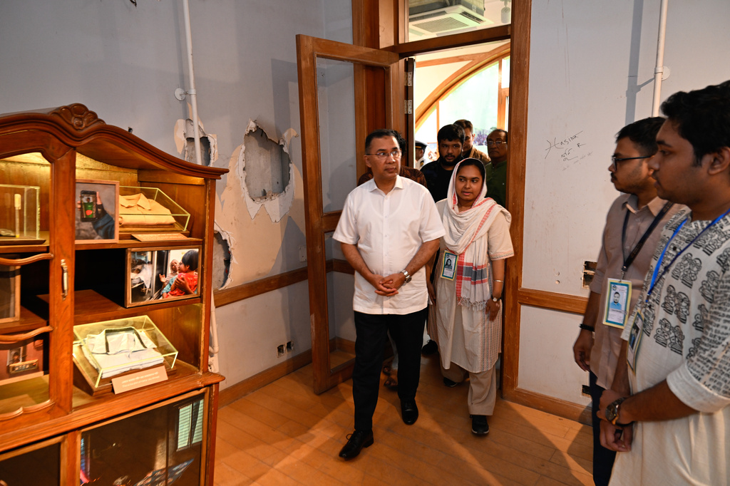 Bangladesh's Prime Minister Tarique Rahman looks at an exhibit at the inauguration of a museum which will serve as a memorial for those killed during the mass uprisings in July 2024, at the former residence of Bangladesh's ousted leader Sheikh Hasina, in Dhaka, Bangladesh, Wednesday, Aug. 5, 2026. (AP Photo/Mahmud Hossain Opu)