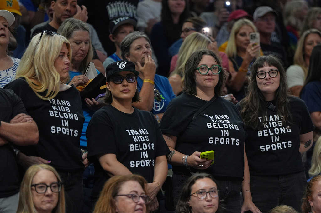 Fans wear shirts saying "Trans Kids Belong In Sports" during a WNBA basketball game between the Minnesota Lynx and the Indiana Fever Sunday, Aug. 2, 2026, in Minneapolis. (AP Photo/Abbie Parr)