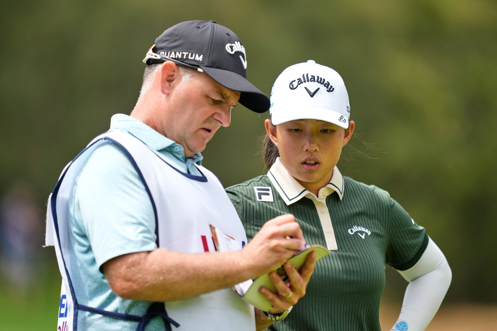 Ruoning Yin, of China, talks with her caddie on the sixth hole during the second round of the U.S. Women's Open golf tournament Friday, June 5, 2026, in the Pacific Palisades area of Los Angeles. (AP Photo/Ashley Landis)