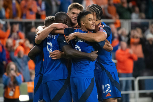 FC Cincinnati forward Brenner, center, looks toward the field while embracing his teammates after forward Kévin Denkey (9) scored during the second half of Game 1 in the first round of MLS soccer's Eastern Conference playoffs against the Columbus Crew, Monday, Oct. 27, 2025, in Cincinnati. (AP Photo/Tanner Pearson) FC Cincinnati forward Brenner, center, looks toward the field while embracing his teammates after forward Kévin Denkey (9) scored during the second half of Game 1 in the first round of MLS soccer's Eastern Conference playoffs against the Columbus Crew, Monday, Oct. 27, 2025, in Cincinnati. (AP Photo/Tanner Pearson)