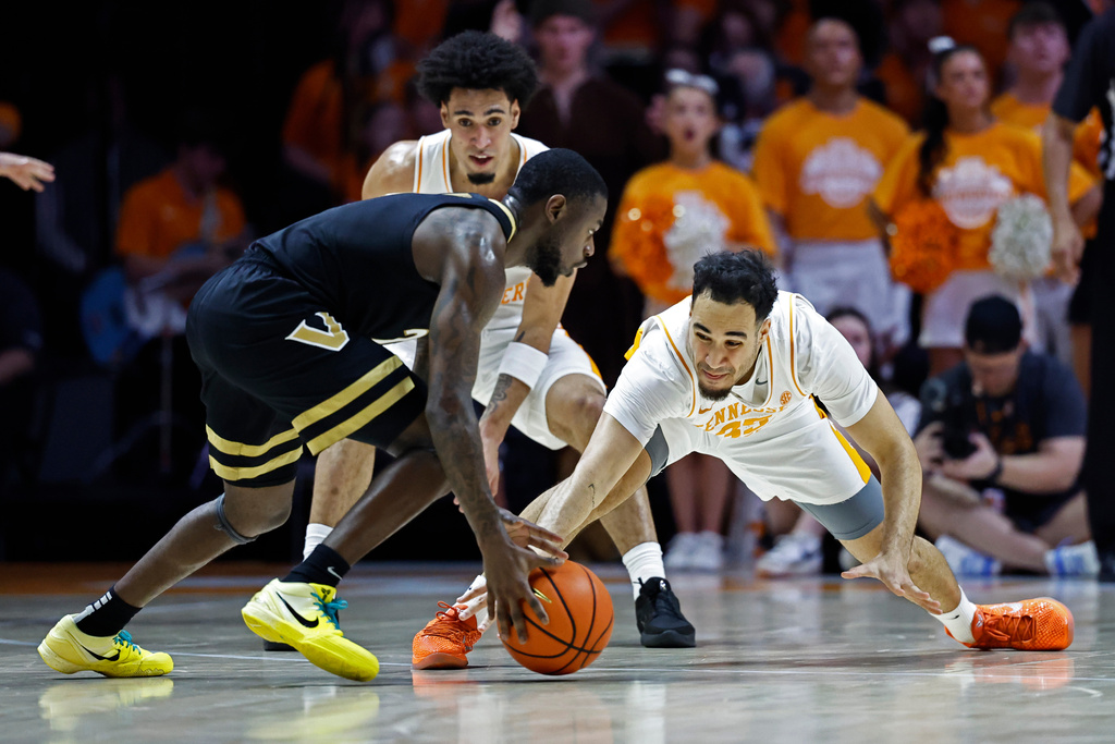 Tennessee guard Ethan Burg (35) tries to steal the ball from Vanderbilt guard Chandler Bing during the first half of an NCAA college basketball game in Knoxville, Tenn., Saturday, March 7, 2026. (AP Photo/Wade Payne)