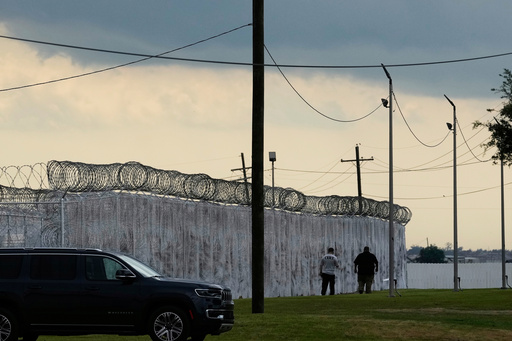 FILE - Security walk outside "Camp 57," a facility to house immigration detainees at the Louisiana State Penitentiary in Angola, La., on Sept. 3, 2025. (AP Photo/Gerald Herbert, File) FILE - Security walk outside "Camp 57," a facility to house immigration detainees at the Louisiana State Penitentiary in Angola, La., on Sept. 3, 2025. (AP Photo/Gerald Herbert, File)
