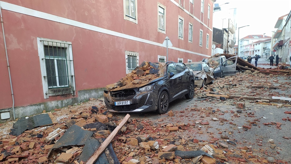 Cars are seen damaged after a building's roof collapsed on them during the passage of storm Kristin in Figueira da Foz, Portugal, Wednesday, Jan. 28, 2026. (Figueira Na Hora/Jorge Lemos via AP)