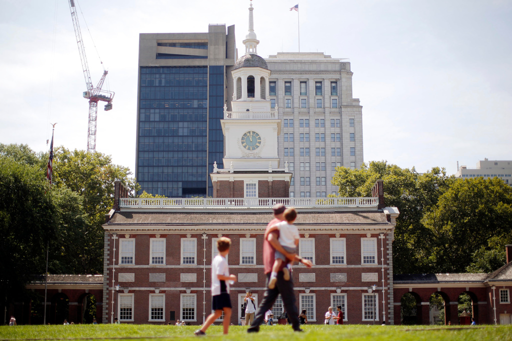 FILE- People move past Independence Hall at the Independence National Historical Park in Philadelphia, Aug. 25, 2016. (AP Photo/Matt Rourke, File)