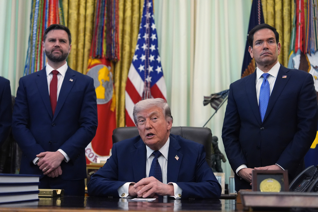 President Donald Trump speaks as Secretary of State Marco Rubio, right, and Vice President JD Vance listen in the Oval Office at the White House, Thursday, April 23, 2026, in Washington. (AP Photo/Mark Schiefelbein)