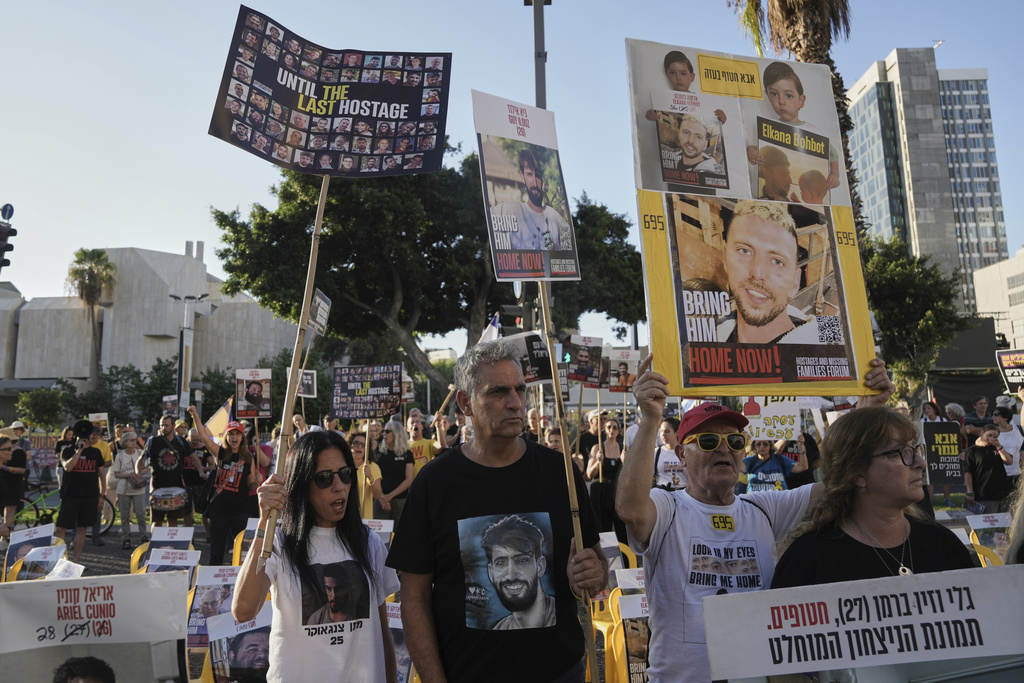 Relatives and supporters of hostages held by Hamas in the Gaza Strip take part in a protest demanding their immediate release and against the Israeli offensive in Gaza City, as they gather in Tel Aviv, Sunday, Aug. 31, 2025. (AP Photo/Mahmoud Illean)