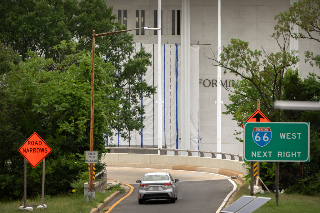 The John F. Kennedy Center for the Performing Arts is seen as its sign remains covered by a tarp, Friday, June 19, 2026, in Washington. (AP Photo/Mark Schiefelbein)