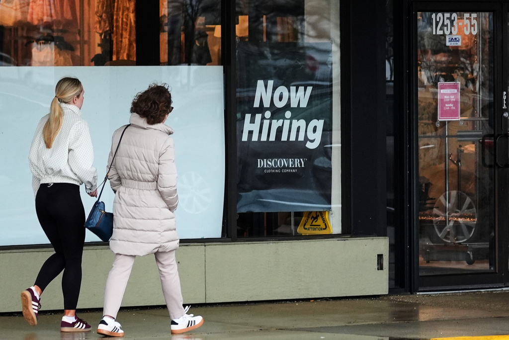 Now hiring sign is displayed at a retail store, in Arlington Heights, Ill., Thursday, April 2, 2026. (AP Photo/Nam Y. Huh)