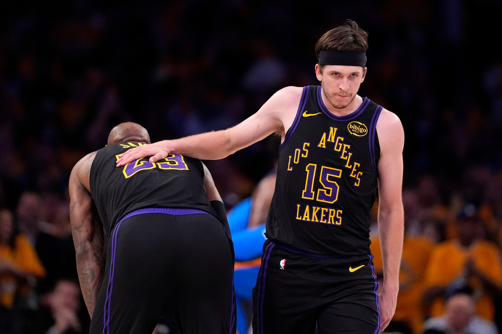 Los Angeles Lakers guard Austin Reaves, right, pats the back of forward LeBron James in the closing minutes of Game 4 in a second-round NBA basketball playoffs series against the Oklahoma City Thunder, Monday, May 11, 2026, in Los Angeles. (AP Photo/Mark J. Terrill)
