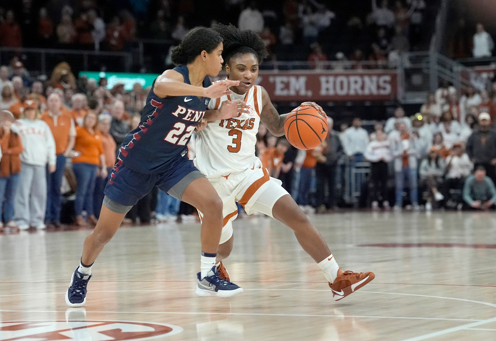 Texas guard Rori Harmon drives against Penn guard Mataya Gayle during the first half of an NCAA college basketball game in Austin, Texas, Sunday, Nov. 30, 2025. (AP Photo/Rodolfo Gonzalez)