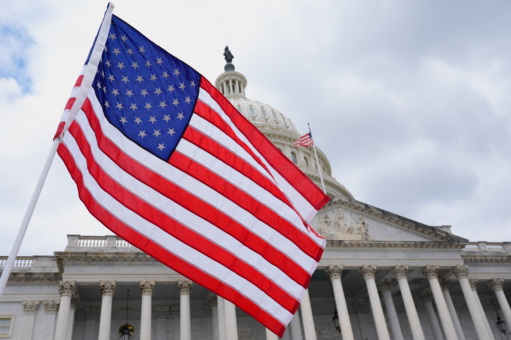 FILE - The U.S. flag flies in font of the Capitol, on June 8, 2026, in Washington. (AP Photo/Mariam Zuhaib, File)