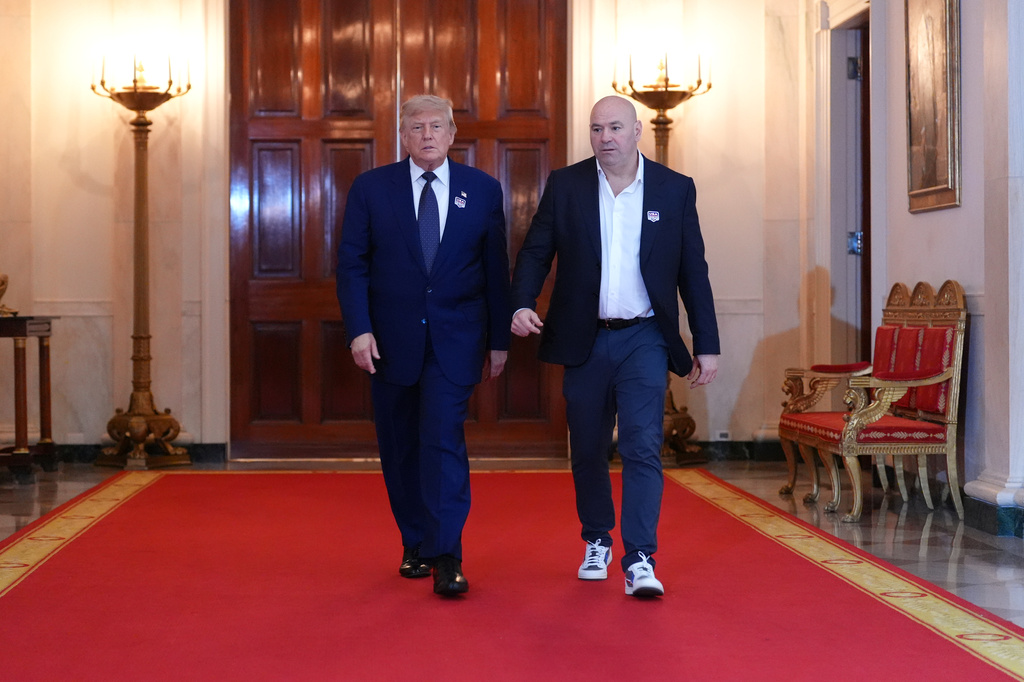 President Donald Trump walks with UFC president and CEO Dana White through the Cross Hall of the White House before attending the UFC Freedom 250 fights on the South Lawn of the White House, Sunday, June 14, 2026, in Washington. (AP Photo/Jacquelyn Martin, Pool)
