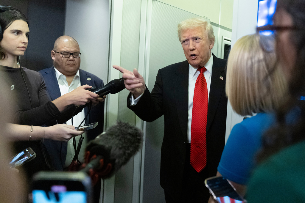 President Donald Trump speaks to reporters on board Air Force One on his way back to the White House from a weekend trip at his Mar-a-Lago estate in Palm Beach, Fla., Sunday, Nov. 2, 2025. (AP Photo/Manuel Balce Ceneta)