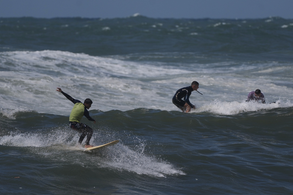 Palestinian Khalil Abu Jayyab rides a wave at a beach along the Mediterranean Sea in Gaza City, Monday, May 4, 2026. (AP Photo/Jehad Alshrafi)