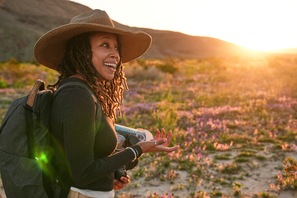 Photographer Krystle Hickman photographs wild bees as desert sunflowers blanket the valley floor at Anza-Borrego Desert State Park in San Diego County, Calif., on Saturday, Feb. 7, 2026. (AP Photo/Damian Dovarganes)