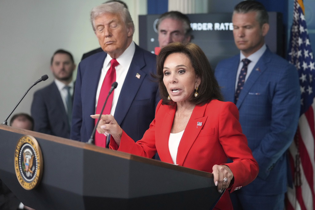 U.S. Attorney Jeanine Pirro speaks with reporters as President Donald Trump, from left, Interior Secretary Doug Burgum and Defense Secretary Pete Hegseth listen in the James Brady Press Briefing Room at the White House, Monday, Aug. 11, 2025, in Washington. (AP Photo/Mark Schiefelbein)