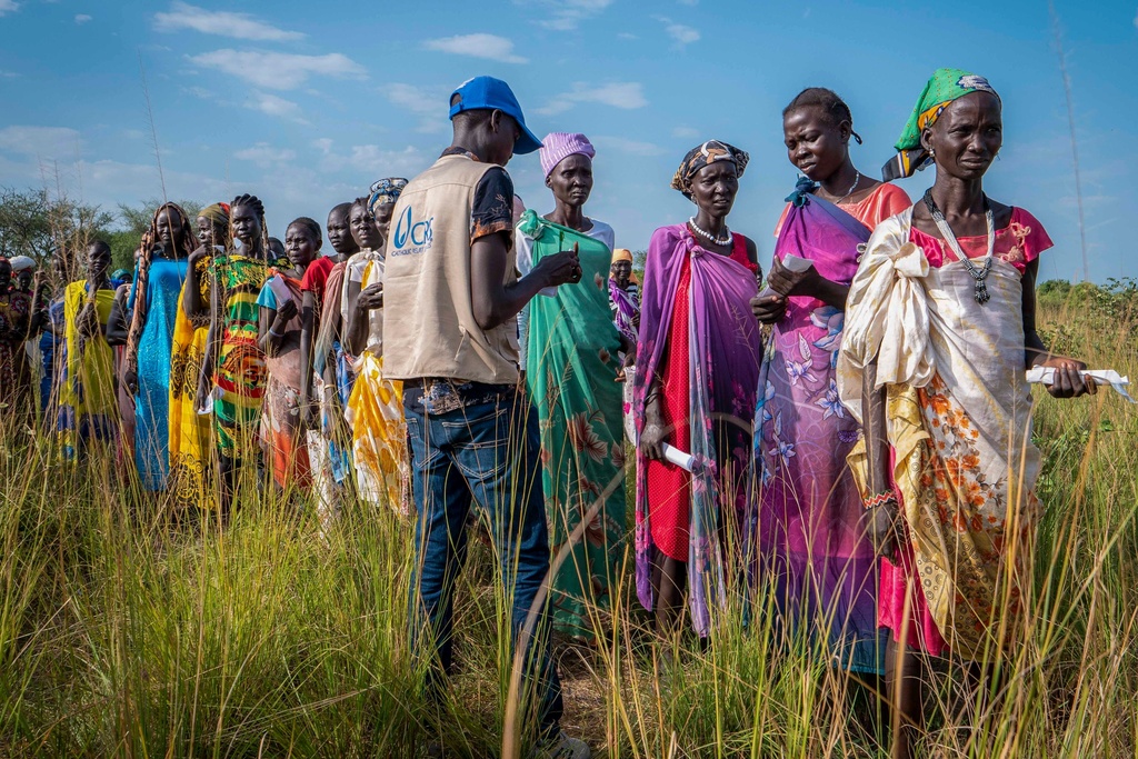 FILE - South Sudanese women line up for food rations at a World Food Programme (WFP) distribution point organized by Catholic Relief Services in Jonglei state, South Sudan, Wednesday, Nov. 13, 2024. (AP Photo/Florence Miettaux, File)
