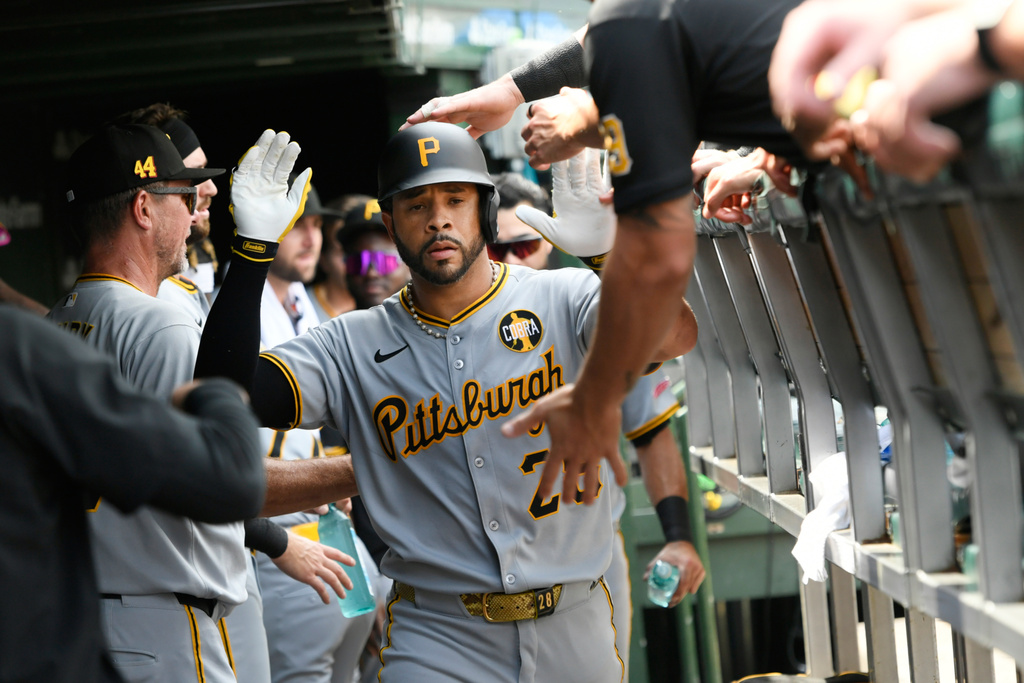 Pittsburgh Pirates Tommy Pham celebrates with teammates in the dugout after hitting a solo home run during the fourth inning of a baseball game against the Chicago Cubs, Saturday, Aug. 16, 2025, in Chicago. (AP Photo/Paul Beaty)