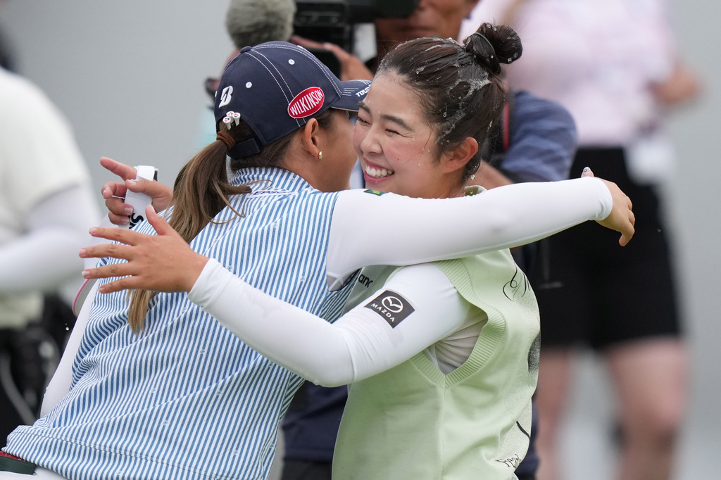 Miyu Yamashita, right, of Japan, celebrates with Yuri Yoshida, of Japan, after winning the LPGA Canadian Women's Open golf tournament in Edmonton, Alberta, Sunday, Aug. 23, 2026. (Darryl Dyck/The Canadian Press via AP)