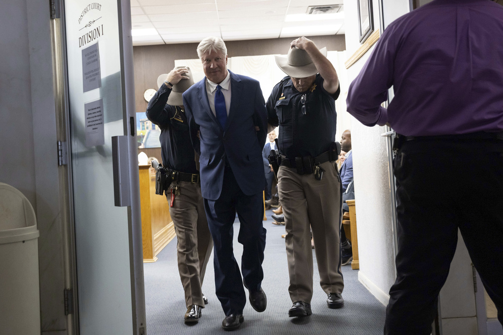 Texas megachurch founder Robert Morris is escorted out of the courthouse after pleading guilty to lewd and indecent acts with a child at the Osage County Courthouse in Pawhuska, Okla., on Thursday, Oct. 2, 2025. (Juan Figueroa/The Dallas Morning News via AP)