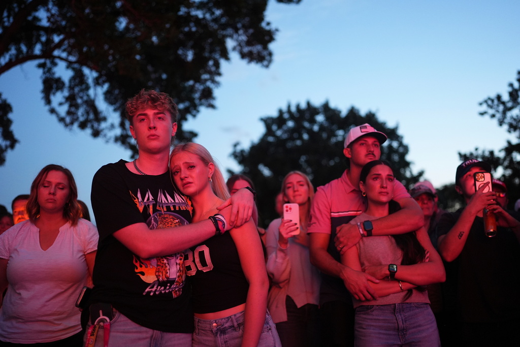 FILE - Utah Valley University students Zach Zimmerman, second from left, and Lauren Simons embrace during a vigil for Charlie Kirk, the CEO and co-founder of Turning Point USA who was shot and killed, Thursday, Sept. 11, 2025, in Orem, Utah. Zimmerman witnessed the shooting. (AP Photo/Lindsey Wasson, File)