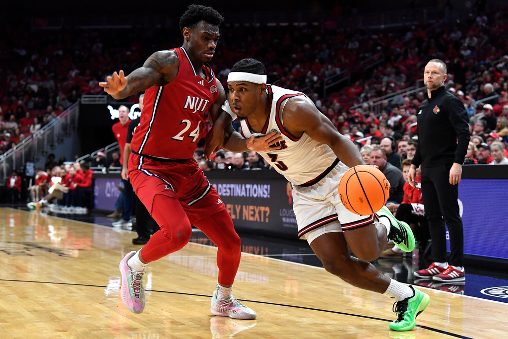 Louisville guard Ryan Conwell (3) drives past NJIT guard Ari Fulton (24) during the second half of an NCAA college basketball game in Louisville, Ky., Wednesday, Nov. 26, 2025. (AP Photo/Timothy D. Easley)