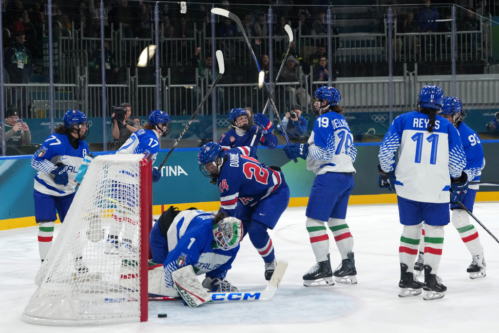 Team United States players celebrate after a goal by Britta Curl, center top, during the second period of a women's ice hockey quarterfinal match between the United States and Italy at the 2026 Winter Olympics, in Milan, Italy, Friday, Feb. 13, 2026. (AP Photo/Carolyn Kaster)