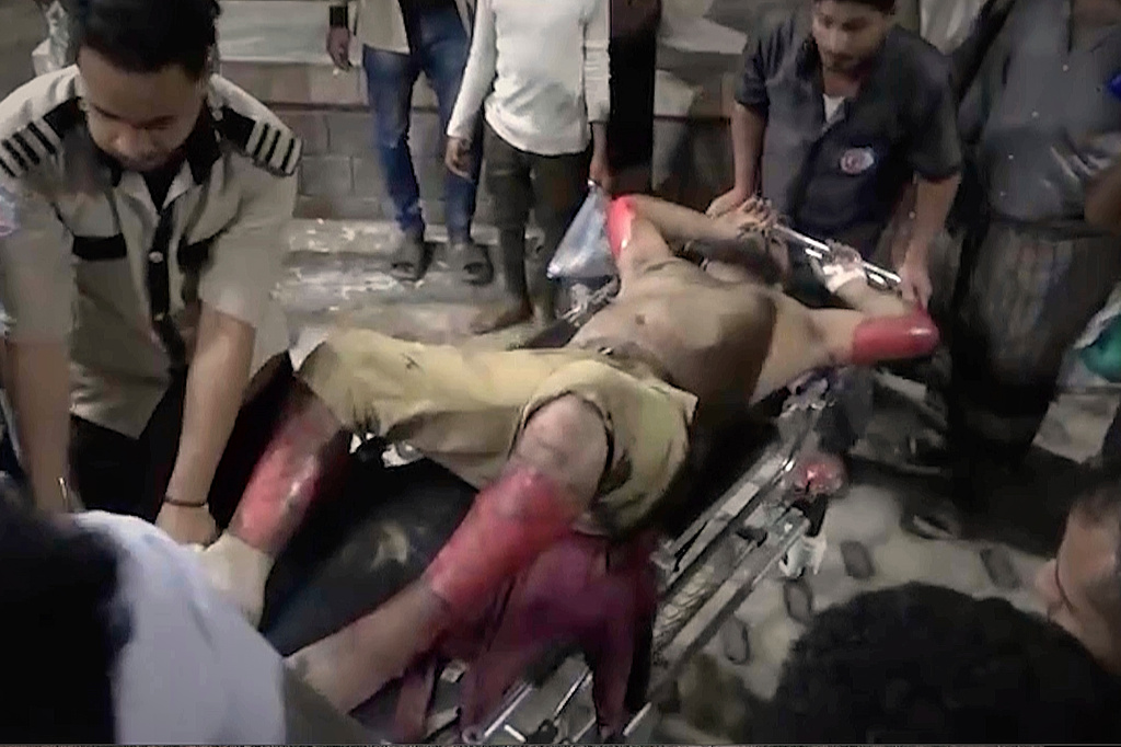 FILE - This photo taken from video released by Al Masirah TV channel shows medics carrying a wounded man into the hospital after U.S. airstrikes targeted the Ras Isa oil port held by Yemen's Houthi rebels in Hodeida, Yemen, April 18, 2025.( Al Masirah TV via AP, File)