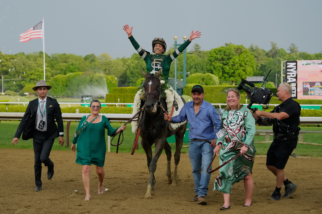 Jockey Jose Ortiz celebrates aboard Golden Tempo as they are led to the winner's circle after winning the 158th running of the Belmont Stakes horse race, Saturday, June 6, 2026, in Saratoga Springs, N.Y. (AP Photo/Yuki Iwamura)