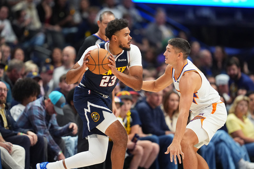 Denver Nuggets forward Cameron Johnson, left, looks to pass the ball as Phoenix Suns guard Grayson Allen, right, defends in the first half of an NBA basketball game Saturday, Oct. 25, 2025, in Denver. (AP Photo/David Zalubowski) Denver Nuggets forward Cameron Johnson, left, looks to pass the ball as Phoenix Suns guard Grayson Allen, right, defends in the first half of an NBA basketball game Saturday, Oct. 25, 2025, in Denver. (AP Photo/David Zalubowski)