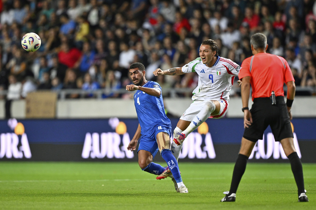 Italy's Mateo Retegui kicks the ball ahead of Israel's Raz Shlomo during a Group I, World Cup qualifier soccer match between Israel and Italy at the Nagyerdei Stadium in Debrecen, Hungary, Monday, Sept. 8, 2025. (AP Photo/Denes Erdos)