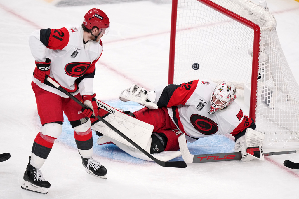 Carolina Hurricanes goaltender Brandon Bussi, right, is scored on by Carolina Hurricanes left wing Nikolaj Ehlers as defenseman Alexander Nikishin watches during the second overtime in Game 3 of the NHL hockey Stanley Cup Final series Saturday, June 6, 2026, in Las Vegas. (AP Photo/Candice Ward)