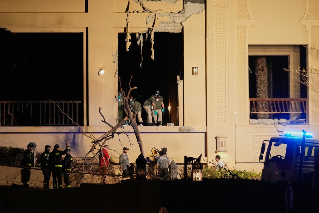 Firemen and rescue workers inspect the site of an explosion at the Fairmont The Palm Hotel in Dubai, United Arab Emirates, Saturday, Feb. 28, 2026. (AP Photo/Altaf Qadri)